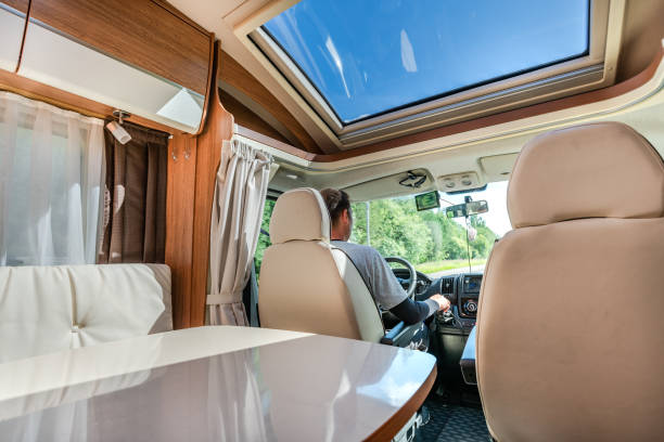 istock Man driving on a road in the Camper Van RV 1183808809