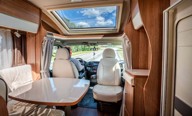 istock Man driving on a road in the Camper Van RV 1183808827