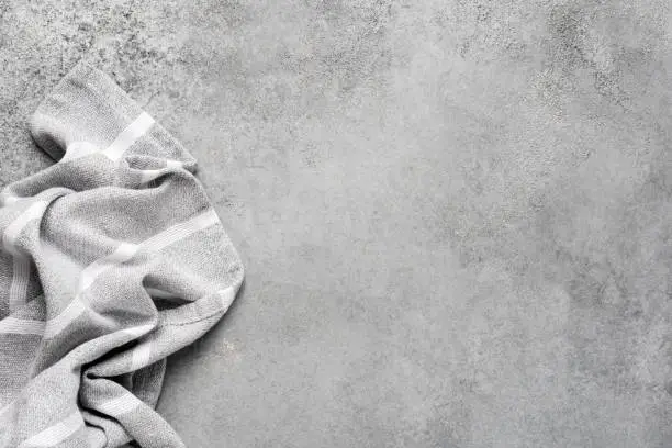 Photo of Linen kitchen napkin on grey concrete background