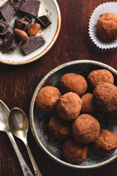 istock Dark chocolate truffles with raw cocoa powder 1183809660