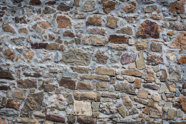 istock Stone wall of rough unprocessed stones 1183810089