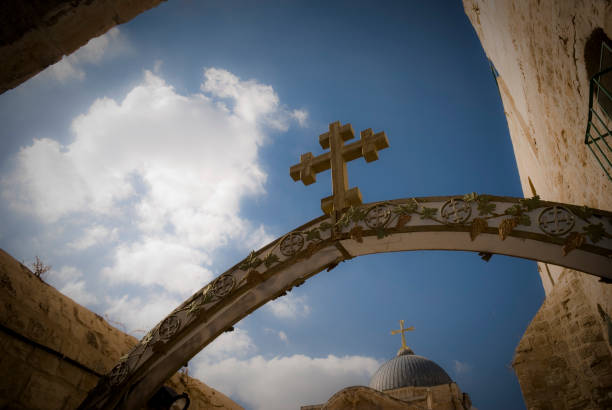 walking The via dolorosa with a wooden cross