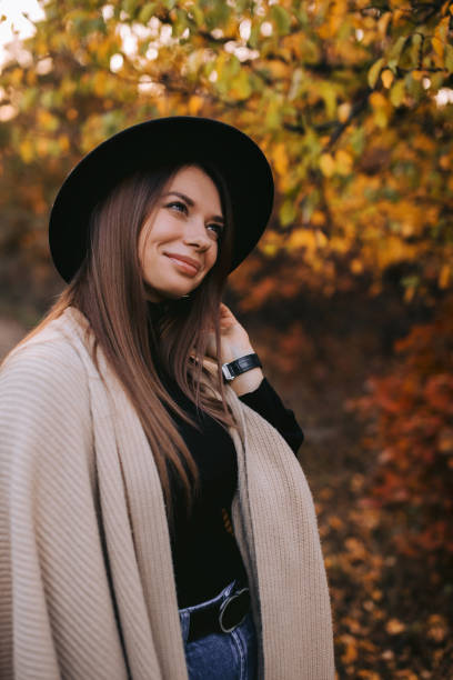istock woman in black hat outdoors in autumn 1183813599