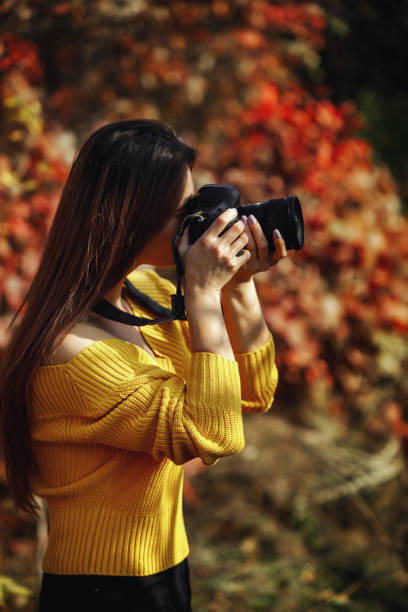 istock women photographer hold camera 1183813621