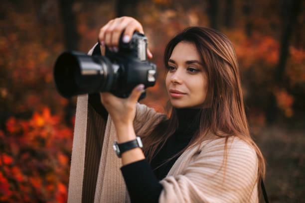 istock women photographer hold camera 1183813638