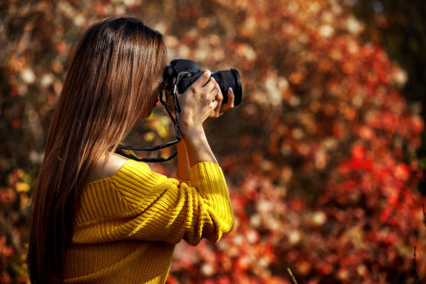 istock women photographer hold camera 1183813653