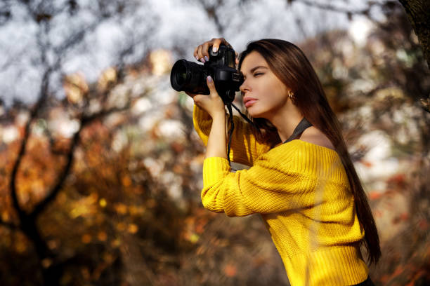istock women photographer hold camera 1183813654