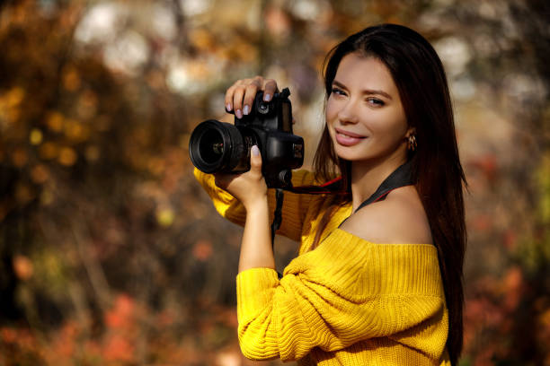 istock women photographer hold camera 1183813684
