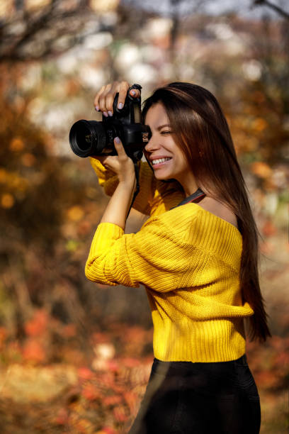 istock women photographer hold camera 1183813758