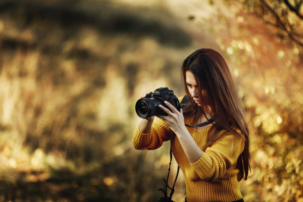 istock women photographer hold camera 1183813818