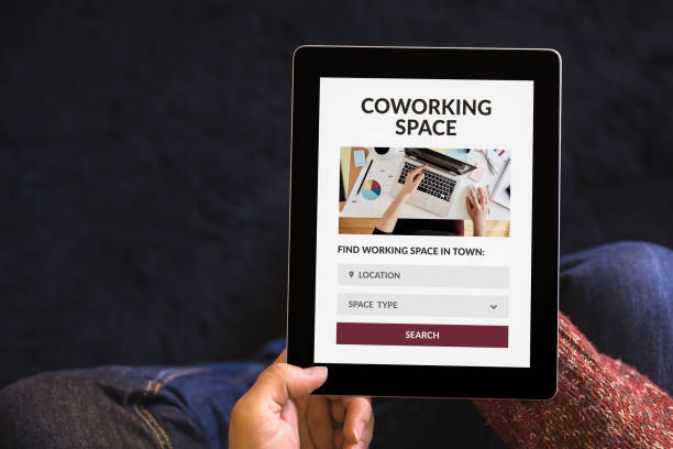 istock Hands holding tablet with coworking space concept on screen 1183814534