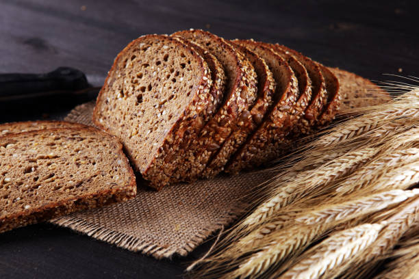 istock freshly baked bread on wooden board. cutted organic bread 1183814551