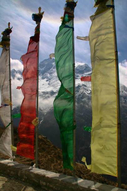 istock 4 colored prayer flags on Solu Khumbu, with Thamserku peak 1183822686