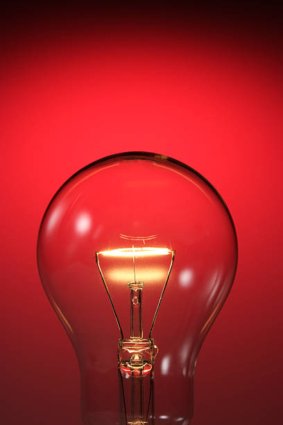 istock Close-up of light bulb against red background with copy space 118382790