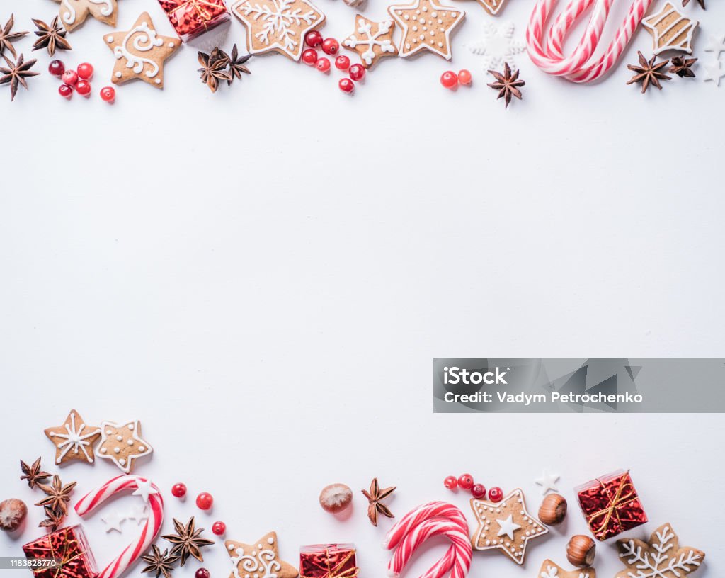 New Year and Christmas greeting postcard Christmas composition, New Year greeting card. Mockup with festive food decorations and gingerbread cookies on white background. Copy space Christmas Stock Photo