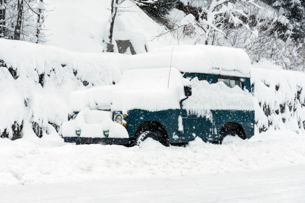 istock Green colored Suv parked in blizzard and covered with snow. 1183828855