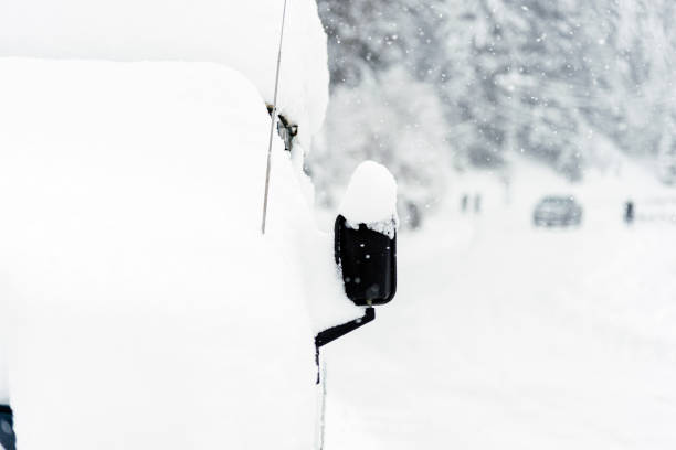 istock Close up of a Suv side view mirror covered with snow under blizzard. 1183828871