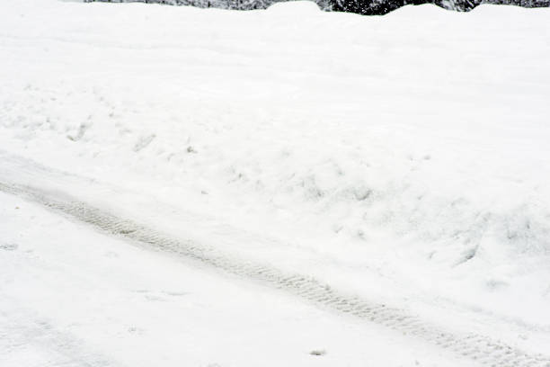 istock Tire tracks on the snowy ground under blizzard. 1183828907