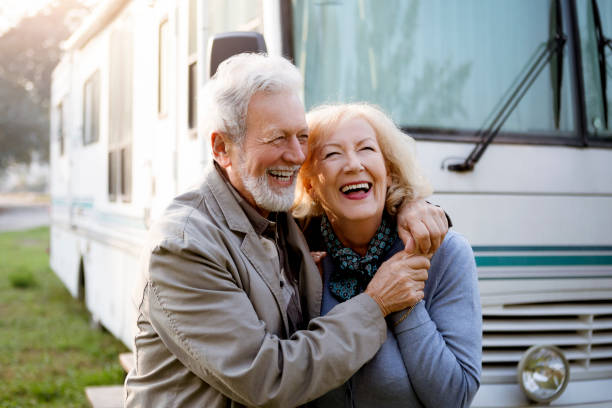 Seniors and Luxury Motor Home ,recreational vehicle Seniors smiling in front of Luxury Motor Home ,recreational vehicle motor home photos stock pictures, royalty-free photos & images