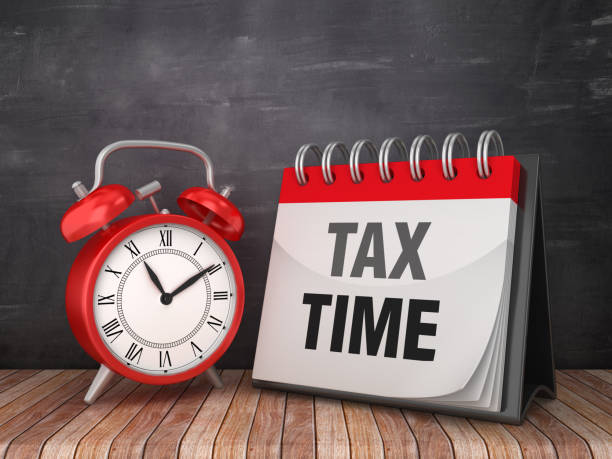 istock TAX TIME Calendar with Alarm Clock on Chalkboard Background - 3D Rendering 1183831305