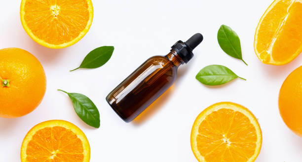 istock Essential oil with fresh orange citrus fruit with leaves isolated on white 1183836382