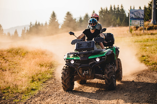Extreme sports couple riding on a quad bike together
