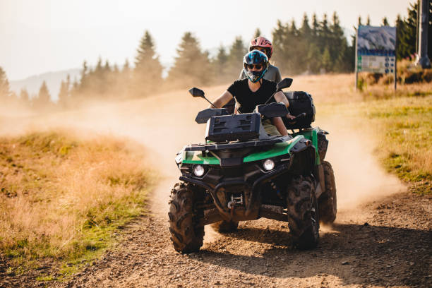Quad bike fun Extreme sports couple riding on a quad bike together off road vehicle stock pictures, royalty-free photos & images