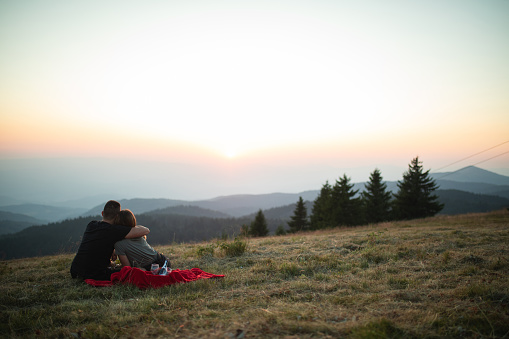 Couple spending celebratory vacation together on a mountain top