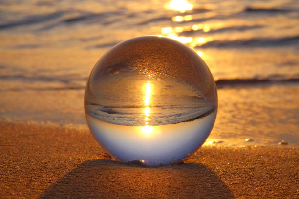 istock Crystal ball on the sand on the beach at sunset. 1183841223