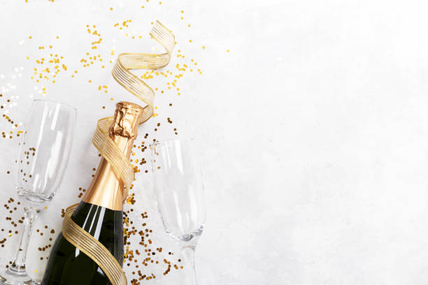 istock Flat lay composition of Champagne bottle and confetti 1183843225