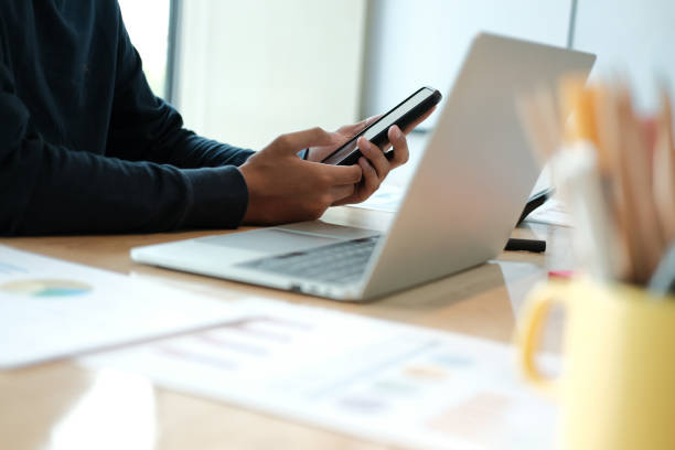 istock male freelancer using mobile smart phone. startup man working at workplace. 1183845924