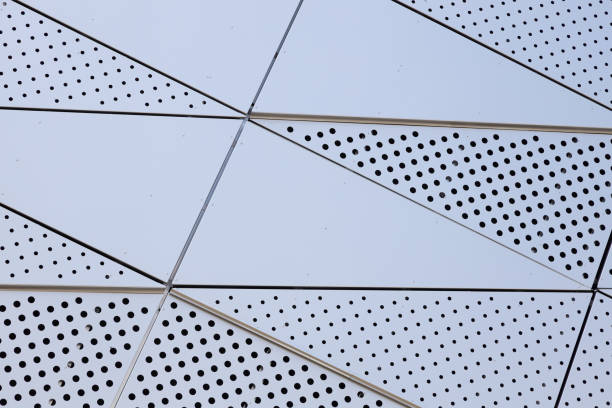 istock White surface of metal wall with round openings 1183846061