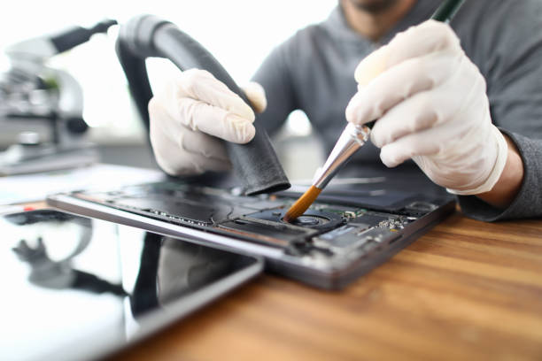 Male chemist in white protective gloves use vacuum