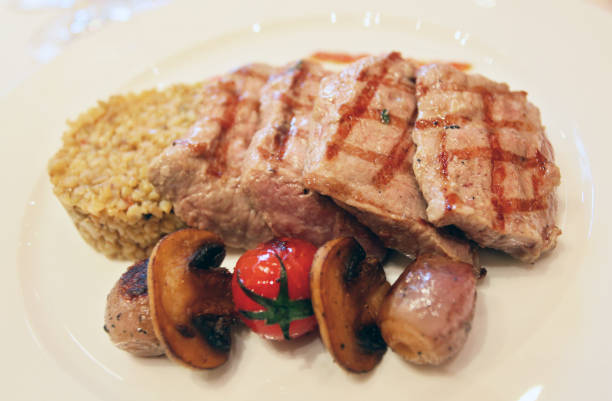 Steak plate with mushrooms, and rice on the restaurant table