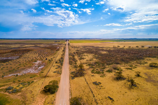 istock Straight unsealed road passing through Australian outback - aerial view 1183851018