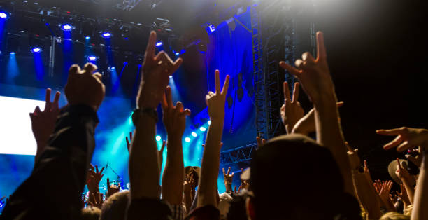 istock Concert arena with fans clapping 1183863973