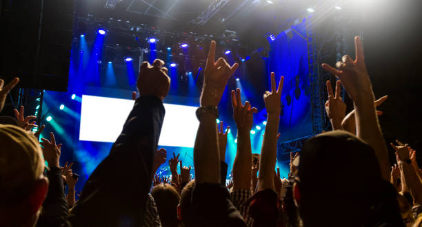 istock Concert arena with fans clapping 1183863986