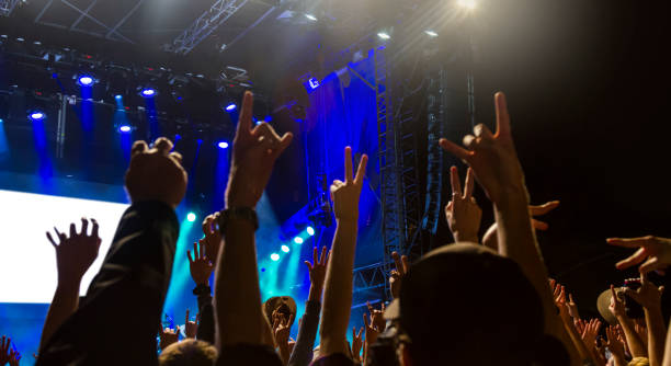 istock Concert arena with fans clapping 1183864028