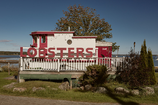 Lincolnville, Maine - September 27th, 2019: Red and white wooden lobster shack on Lincolnville Beach off the coast of Penobscot Bay in Lincolnville, Maine.