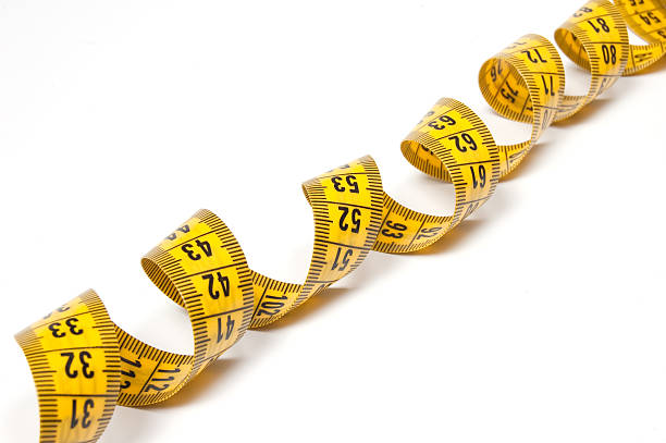istock Coiled yellow measuring tape isolated on white 118386759