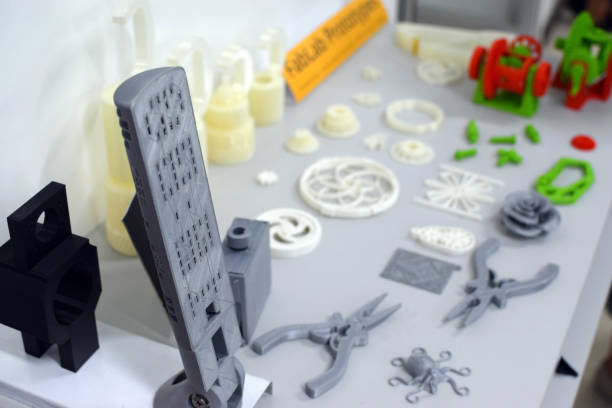 istock 3d print of modern gadget plastic prototype and other items displayed on laboratory table. 1183869364