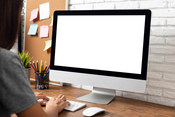 istock woman working empty screen computer on wood desk in home office. 1183870226