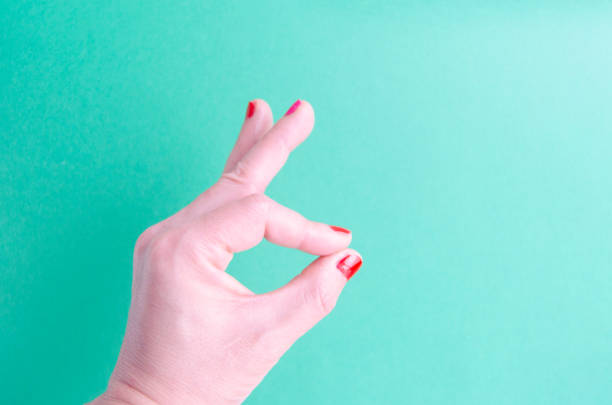 woman hand thumb on the grey  background