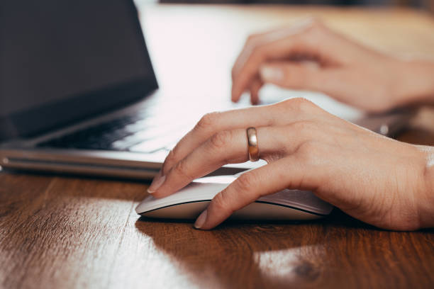 istock Woman using laptop on light table, closeup 1183877669