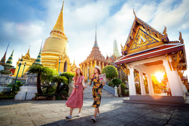 Asian girl walk in Wat phra kaew and grand palace travel in Bangkok city stock photo