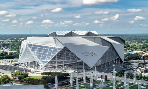 Aerial View of Mercedes Benz Stadium in Atlanta Atlanta, Georgia/ USA - September 8, 2018: Opened in August 2017, Atlanta's iconic Mercedes Benz Stadium can accommodate 71,000 spectators and features a state-of-the-art retractable roof. georgia football stock pictures, royalty-free photos & images