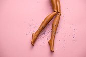 legs of a plastic doll with hair scattered