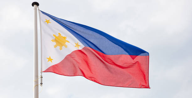 istock Philippines flag waving against cloudy sky background 1183888094