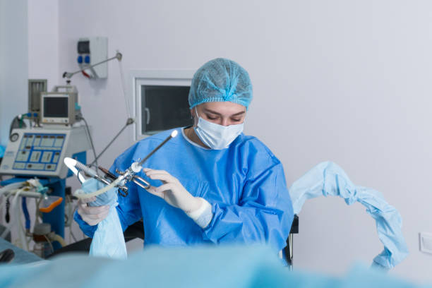 A nurse prepares a medical instrument for surgery. A nurse is preparing a medical instrument for performing a hysteroscopy operation. artificial insemination photos stock pictures, royalty-free photos & images