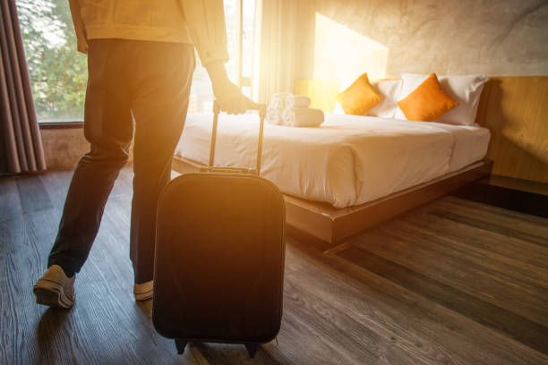 Cropped shot of tourist woman pulling her luggage to her hotel bedroom after check-in. Conceptual of travel and vacation. hotel stock pictures, royalty-free photos & images